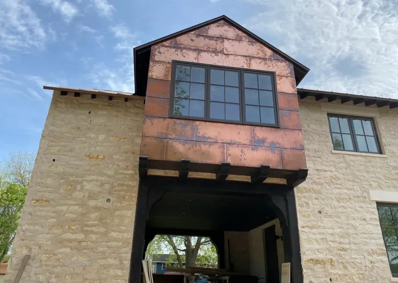 Copper metal panel facade on a stone building for Roof Repair in Searcy